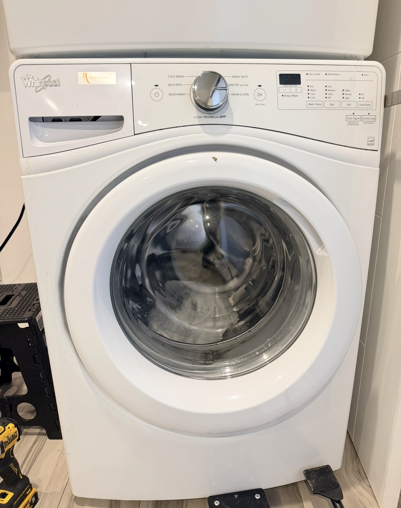 Whirlpool front-load washer during repair Great Kills Staten Island — machine pulled from wall, service in progress