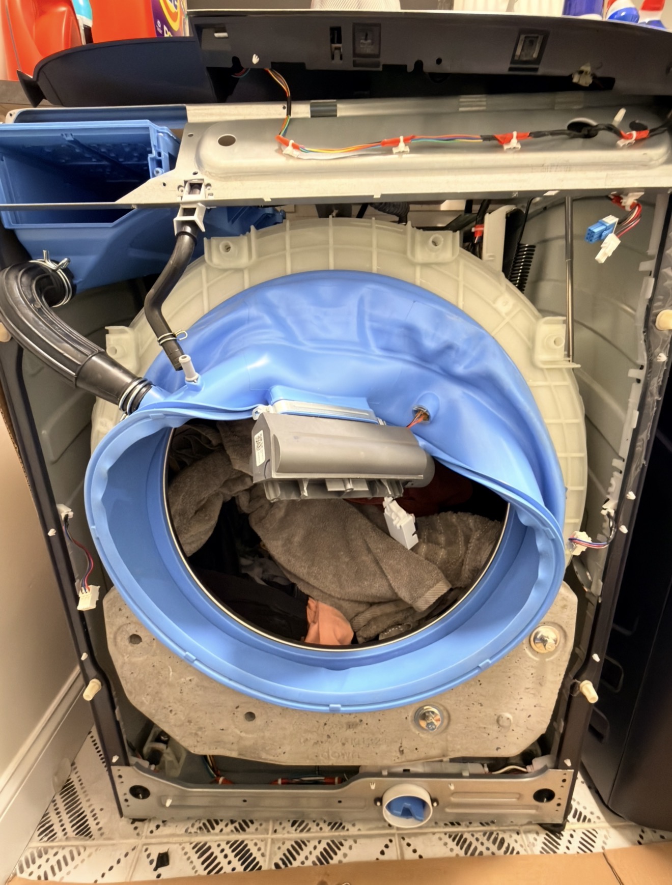 GE front-load washer fully opened showing drain system and internal components — debris filter and drain pump access in Tottenville Staten Island 10307